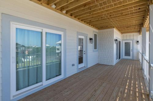 an empty porch with a view of the ocean at Zensation 14 Bedroom Home by KEES Vacations in Salvo