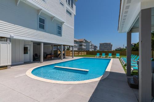 a swimming pool in the backyard of a house at Zensation 14 Bedroom Home by KEES Vacations in Salvo