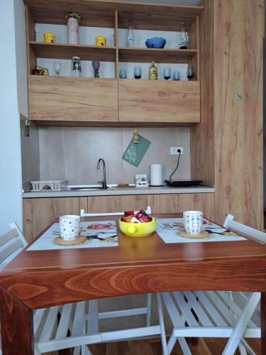 a kitchen with a wooden table with two cups on it at Vila Irina Kopaonik in Kopaonik