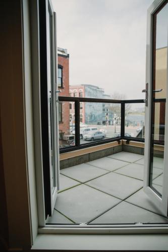 an open window with a view of a city at The Garden Room at Waddington Flats in Victoria