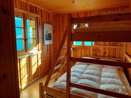 a bedroom with two bunk beds in a cabin at Traditional chalet in the heart of nature in Sarreyer