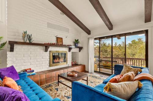 a living room with blue couches and a fireplace at Large Spanish Villa -Hot tub- Pool -Gym- Game Room in Sedona