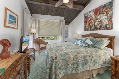 a bedroom with a bed and a flat screen tv at Conveniently located two bedroom two bath HK319 in Wailea