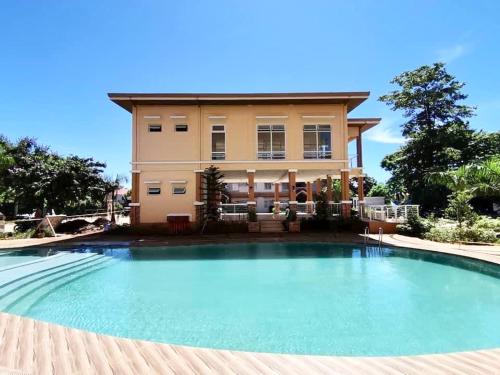 a large swimming pool in front of a house at Condo Home in Puerto Princesa near PPS Airport in Puerto Princesa City