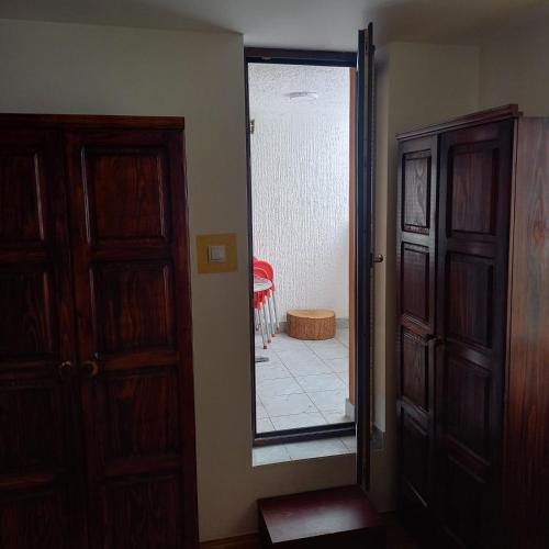 a hallway with a mirror and a door with a room at Medo in Zlatibor