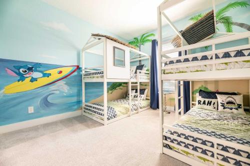 a bedroom with two bunk beds with a surfboard at ET013 - Coastal Townhouse with Themed Bedroom at Reunion in Orlando