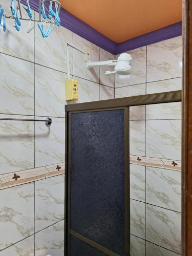 una ducha con paredes de mármol blanco y una puerta negra en Apart Hotel - Alter Temporada, en Manaus