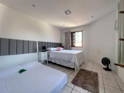 מיטה או מיטות בחדר ב-Beira Mar Continental (mágica!)