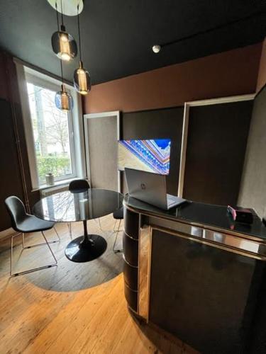 a room with a desk with a laptop on it at La Villa Blanche Spa in Spa