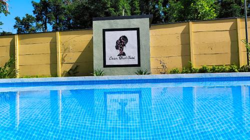 a swimming pool with a sign in front of it at Casa Black Chaini in Puerto Viejo