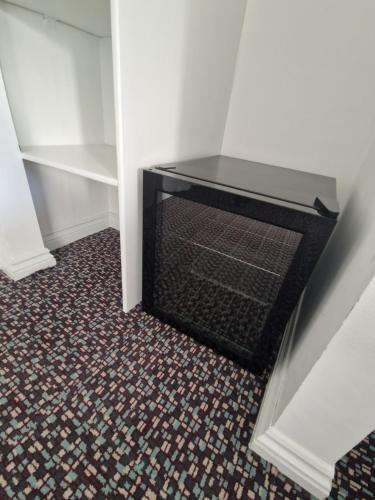 a staircase with a fireplace in the corner of a room at Posyrooms in Manchester