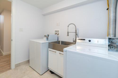 a kitchen with white cabinets and a sink and a sink at My cozy home in Toronto in Toronto