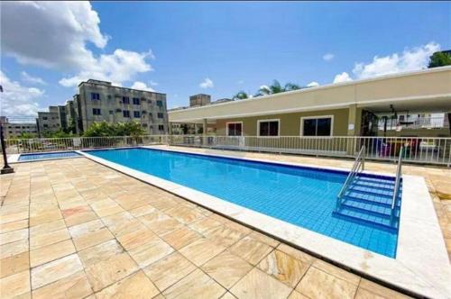 a swimming pool in the middle of a building at Aluguel por temporada mobiliado in Natal