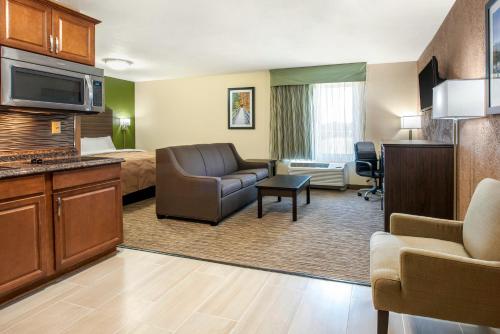 a hotel room with a bed and a living room at Quality Inn & Suites Brandenburg - Fort Knox in Brandenburg