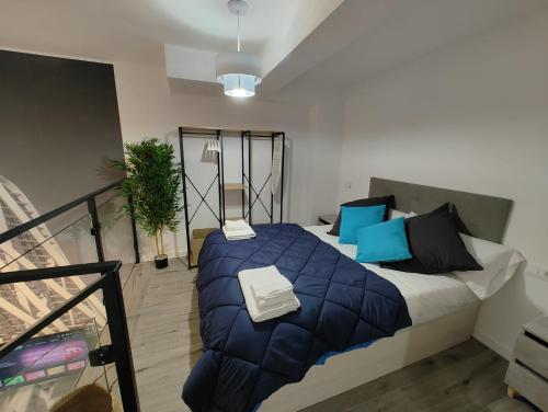 a bedroom with a large bed with blue pillows at Loft Valencia Benimaclet in Valencia