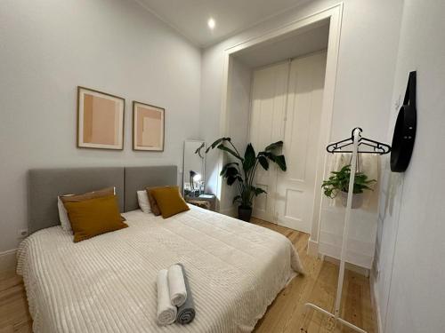 Apartamento no centro de Lisboa tesisinde bir odada yatak veya yataklar