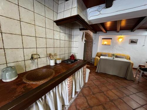 a kitchen with a sink and a table in a room at Casa Tía Isidra - Los Madroñeros 