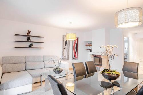 a living room with a table and a couch at Estrella Bahia in Port d'Alcudia