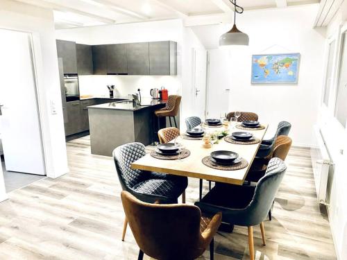 a dining room table and chairs in a kitchen at Unique Penthouse with Gallery and Mountain View in Kandersteg