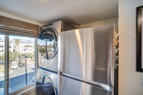 a stainless steel refrigerator in a kitchen with a window at St Helena Island Vacation Rental Walk to Beach! in Oceanmarsh Subdivision