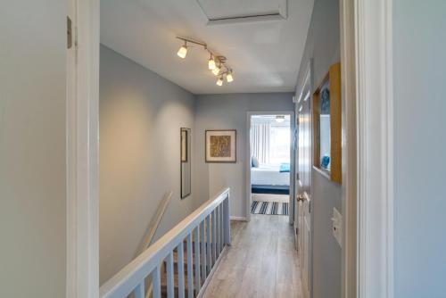 a hallway with a stairway leading to a bedroom at St Helena Island Vacation Rental Walk to Beach! in Oceanmarsh Subdivision