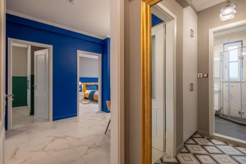 a hallway with blue walls and a mirror at Sofia’s Classy Blu -2 Bedrooms in Sofia