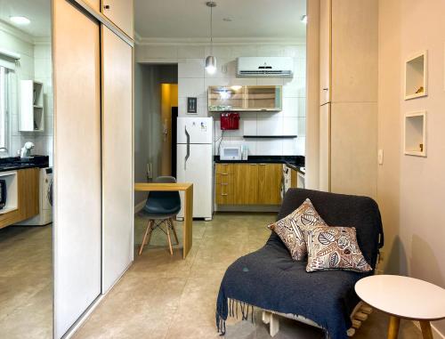 ein Wohnzimmer mit einem Sofa und einer Küche in der Unterkunft Otimo apto a poucos metros da Praia de Botafogo RJ in Rio de Janeiro