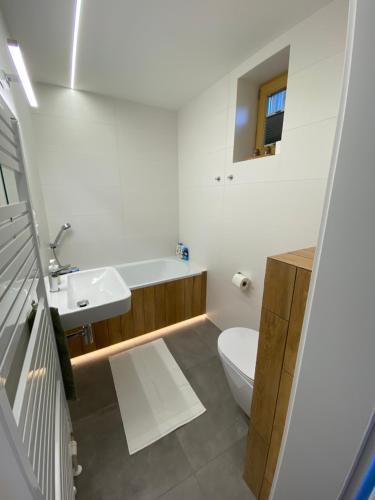 a bathroom with a white toilet and a sink at Chata Petra in Oravský Biely Potok