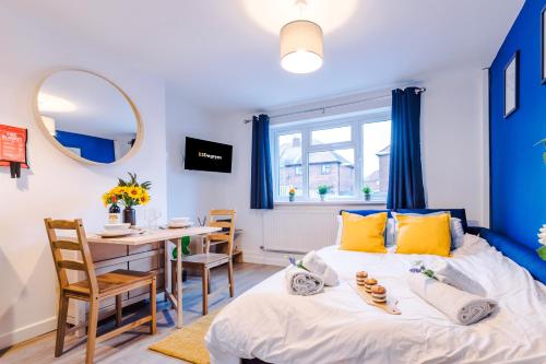 a bedroom with a bed and a table and chairs at NEW! Spacious 2-bed Apartment in Crewe by 53 Degrees Property, ideal for Business & Professionals, FREE Parking - Sleeps 6 in Crewe