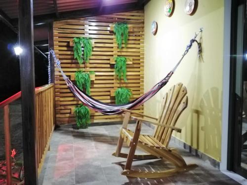 a hammock on the porch of a house at Baruch Tropical Ranch in Los Santos