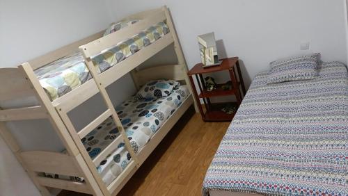 two bunk beds in a room with a bed at Appartement vista mar in Puerto del Rosario