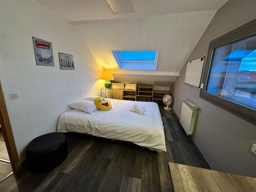 a small bedroom with a bed and a window at Maison vue SEMNOZ in Annecy