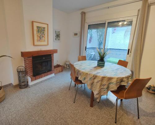 a dining room with a table and a fireplace at ENDAGORA in Níjar