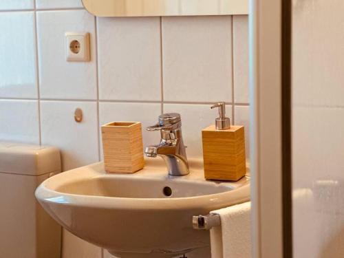 a bathroom with a sink with two boxes on it at Auszeit im Grünen nahe der Heide in Winsen Aller