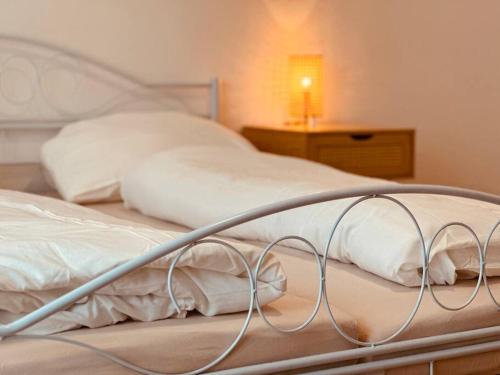 a bedroom with two beds with white sheets and a lamp at Auszeit im Grünen nahe der Heide in Winsen Aller