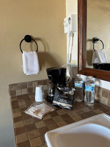 a bathroom counter with a sink and a mirror at Chulavista Loreto in Loreto