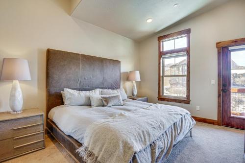 a bedroom with a large bed and two windows at All-Season Heber City Condo with Stunning Views! in Heber City