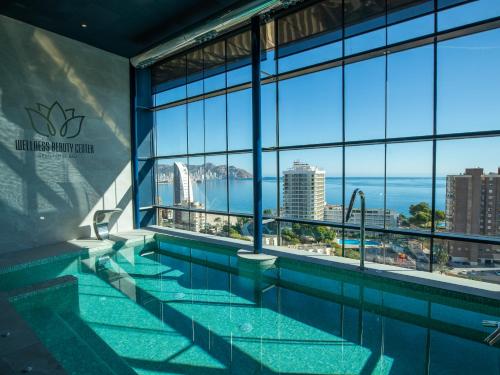 a swimming pool with a view of the ocean at Gran Hotel Bali in Benidorm