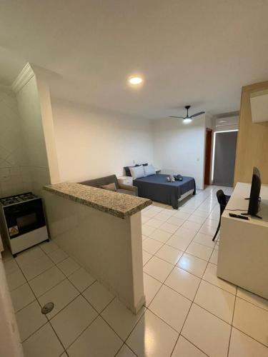 a living room with a couch and a bed in a room at Edifício Belluno in Ribeirão Preto