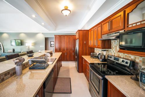 a large kitchen with wooden cabinets and appliances at Bram Villa in Canaan