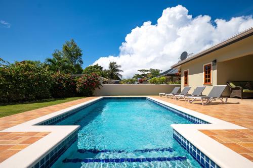 a swimming pool in the backyard of a house at Bram Villa in Canaan