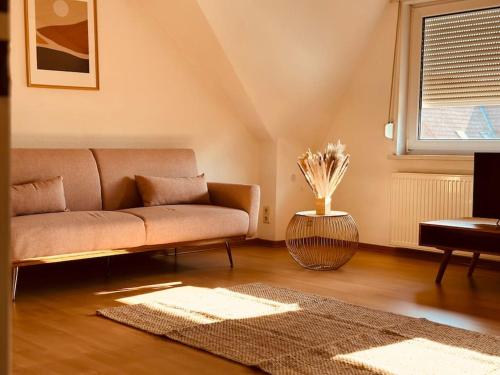 a living room with a couch and a table at Moderne Wohnung in der Heide in Winsen Aller