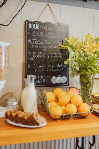 a table with a plate of bread and a chalkboard at Hostal Viento Sur in Coihaique