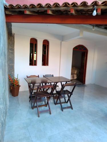 einen Holztisch und Stühle in einem Zimmer in der Unterkunft Casa na Praia de itacimirim Vila Maria in Camassari