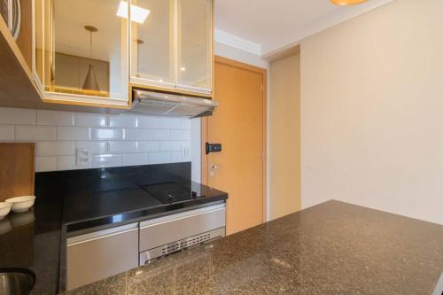 a kitchen with a black counter top and a stove at Elegant Studio - GRU 1506 in Guarulhos