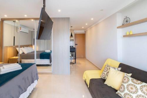 a living room with a couch and a bedroom at Elegant Studio - GRU 1506 in Guarulhos