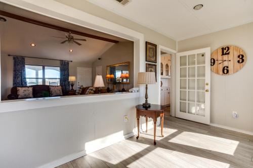 a living room with a table and a clock on the wall at On-Site Lake Access and Fire Pit Bonham Home! in Bonham