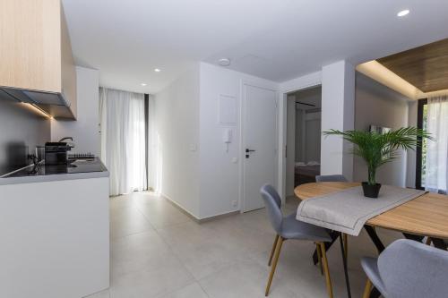 a kitchen and dining room with a table and chairs at Varkiza Luxury Suites by Raise in Vari