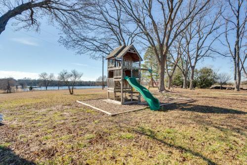 a playground with a slide in a park at On-Site Lake Access and Fire Pit Bonham Home! in Bonham