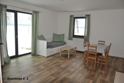 a living room with a couch and a table and chairs at Apartmány Benátky in Suchdol nad Lužnicí
